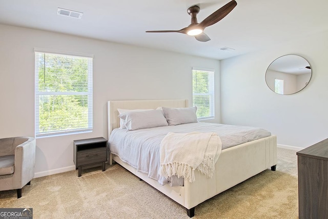 bedroom featuring light carpet and ceiling fan