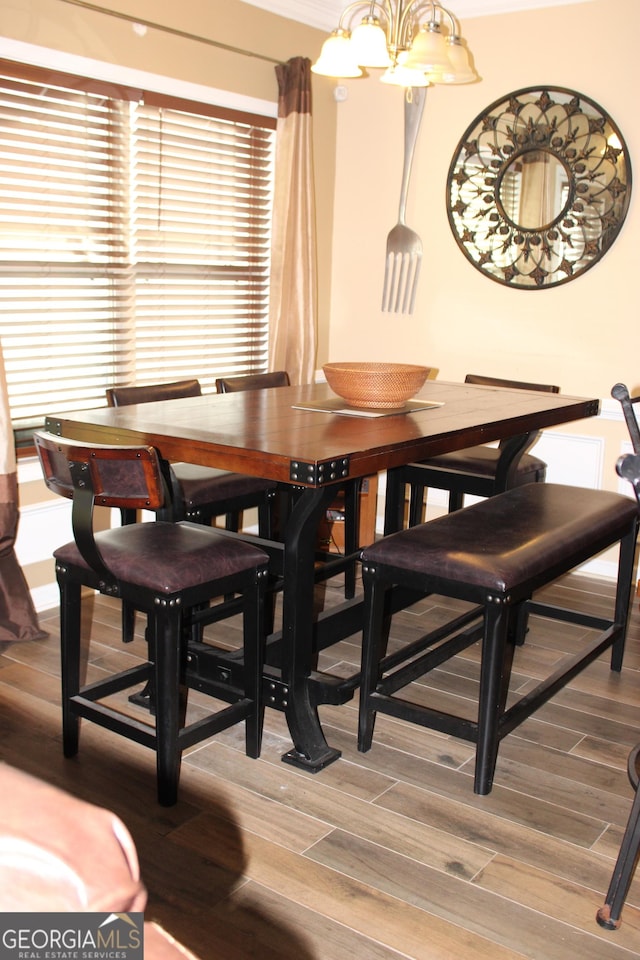 dining room with a notable chandelier and wood finished floors