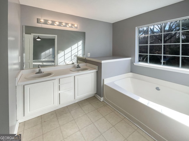 bathroom with tile patterned flooring, vanity, and a bathtub