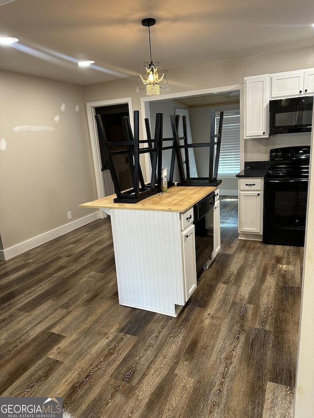 kitchen featuring black appliances, white cabinets, wooden counters, and decorative light fixtures