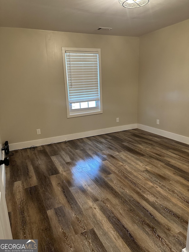 unfurnished room featuring dark hardwood / wood-style floors