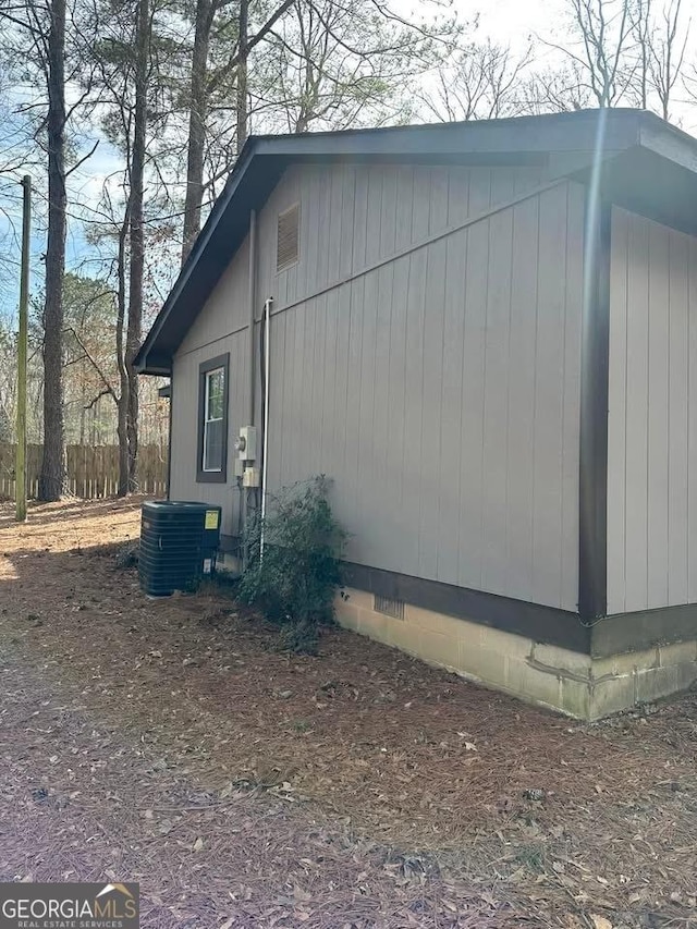 view of side of property featuring central AC