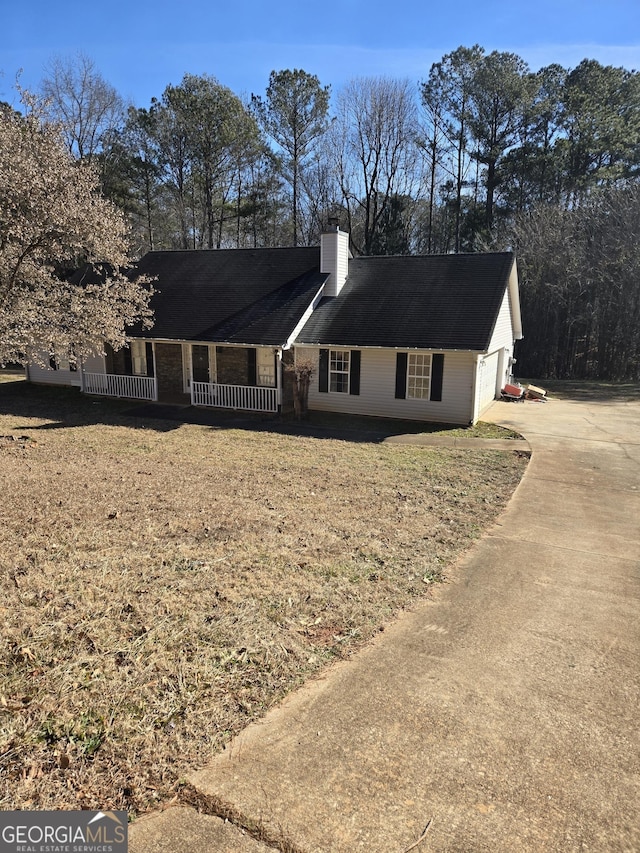 single story home with a garage, a chimney, a porch, and concrete driveway