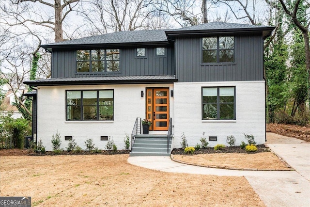 modern farmhouse with a shingled roof, crawl space, and brick siding