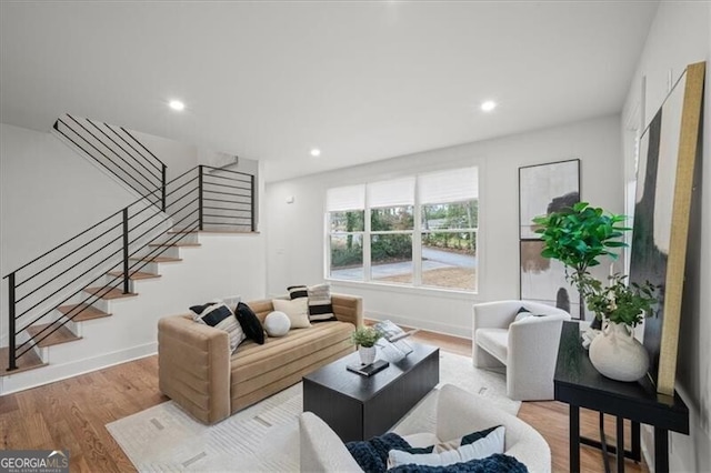 living room with baseboards, stairway, wood finished floors, and recessed lighting