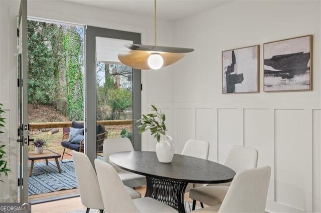 dining room featuring a wainscoted wall and a decorative wall