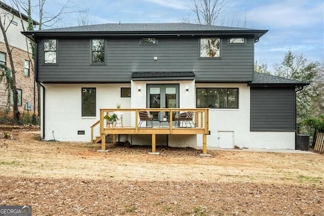 rear view of property featuring brick siding, crawl space, a shingled roof, and a wooden deck