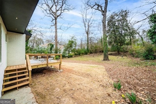 view of yard with a wooden deck