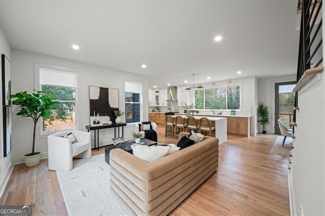 living area featuring recessed lighting and light wood-style floors