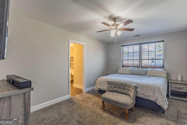 bedroom with ceiling fan, carpet flooring, and a textured ceiling