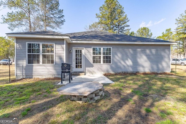 back of house featuring a patio and a lawn