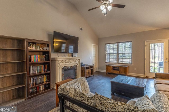 living room with ceiling fan, dark hardwood / wood-style flooring, and high vaulted ceiling