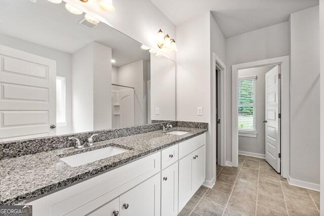 910 Bevis Rd, Franklin, GA 30217 - full bath with double vanity, baseboards, and tile patterned floors