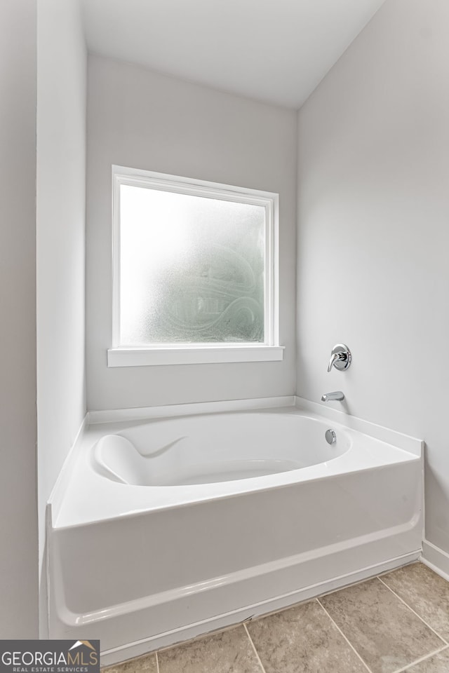 910 Bevis Rd, Franklin, GA 30217 - bathroom featuring a garden tub and tile patterned floors