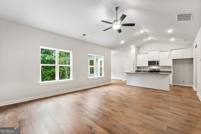 910 Bevis Rd, Franklin, GA 30217 - unfurnished living room featuring a ceiling fan, light wood-style flooring, baseboards, beam ceiling, and high vaulted ceiling