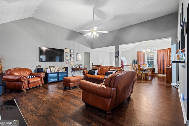 living room with ceiling fan with notable chandelier, dark hardwood / wood-style floors, and vaulted ceiling