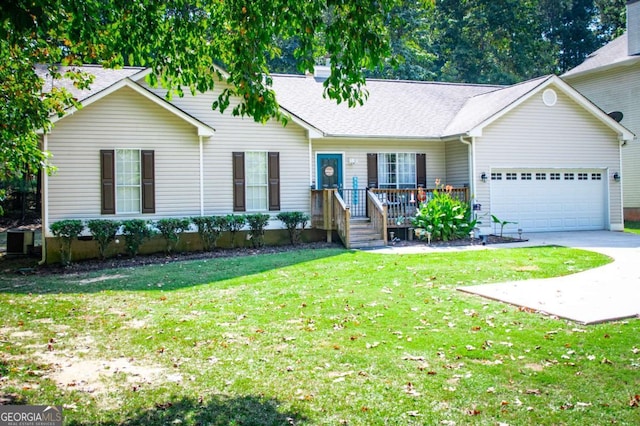 single story home featuring a garage and a front lawn