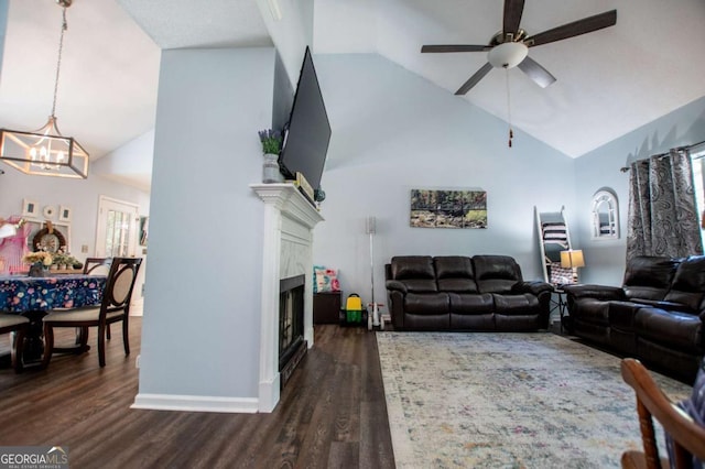 living room featuring high vaulted ceiling, ceiling fan with notable chandelier, a fireplace, and dark hardwood / wood-style flooring