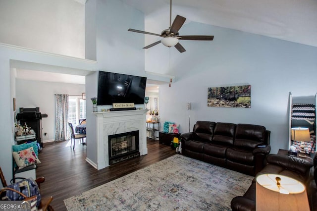 living room featuring ceiling fan, high vaulted ceiling, dark hardwood / wood-style floors, and a high end fireplace