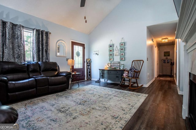 living room featuring ceiling fan, dark hardwood / wood-style floors, and high vaulted ceiling