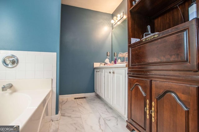 bathroom featuring vanity and a tub