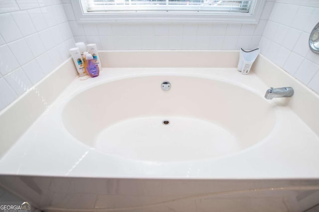 bathroom featuring a washtub and a wealth of natural light