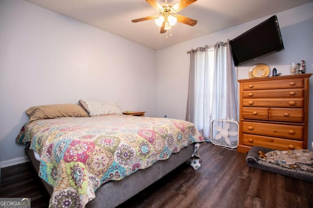 bedroom with dark hardwood / wood-style floors and ceiling fan