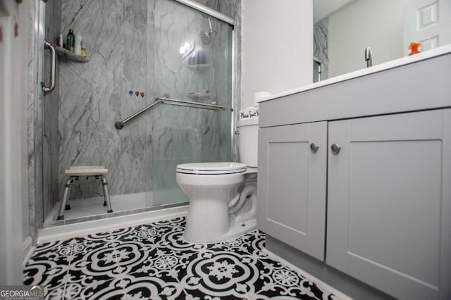 bathroom featuring vanity, an enclosed shower, tile patterned flooring, and toilet