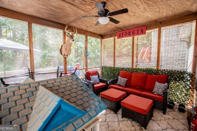 sunroom with ceiling fan and wood ceiling