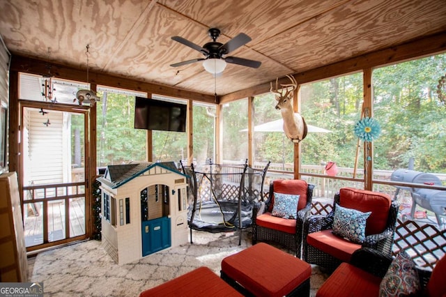 sunroom / solarium with wooden ceiling and ceiling fan