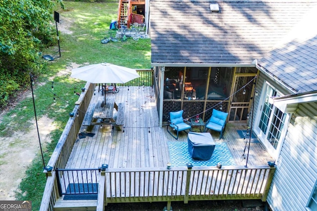 wooden terrace with a lawn