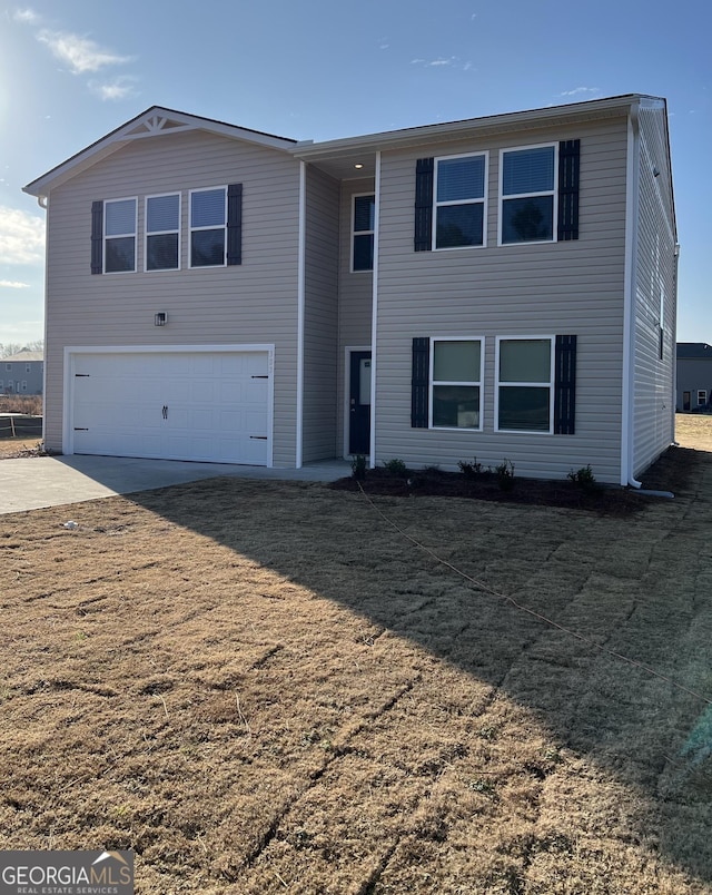 view of front of home featuring a garage and a front yard