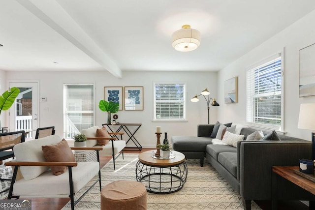 living room featuring beamed ceiling and light wood-type flooring