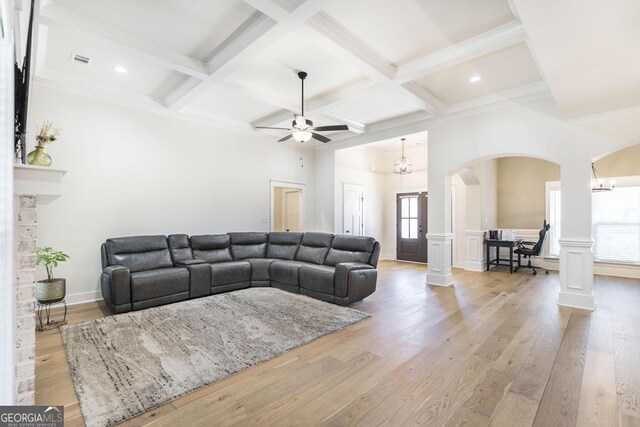 kitchen featuring tasteful backsplash, custom exhaust hood, stainless steel appliances, and light wood-type flooring