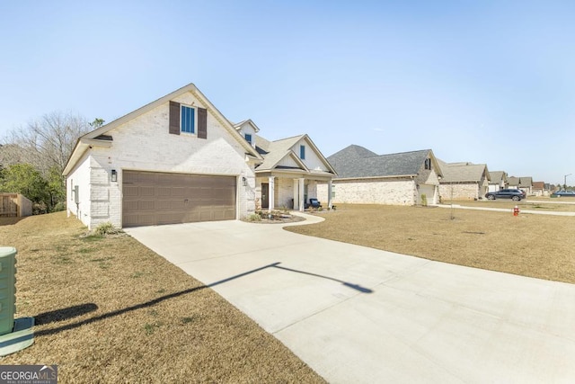 traditional-style house with a garage, concrete driveway, and brick siding