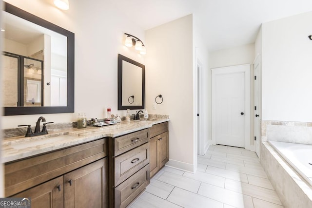 full bath featuring double vanity, a stall shower, a garden tub, and a sink