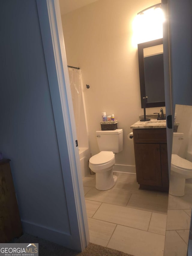 bathroom featuring tile patterned floors, vanity, and toilet