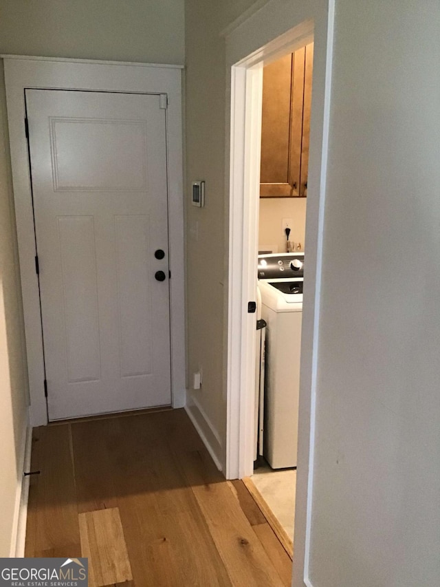 doorway to outside featuring washer / dryer and light wood-type flooring