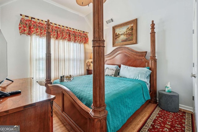 bedroom featuring vaulted ceiling and hardwood / wood-style floors