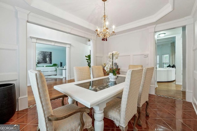 tiled dining space with ornamental molding and a chandelier