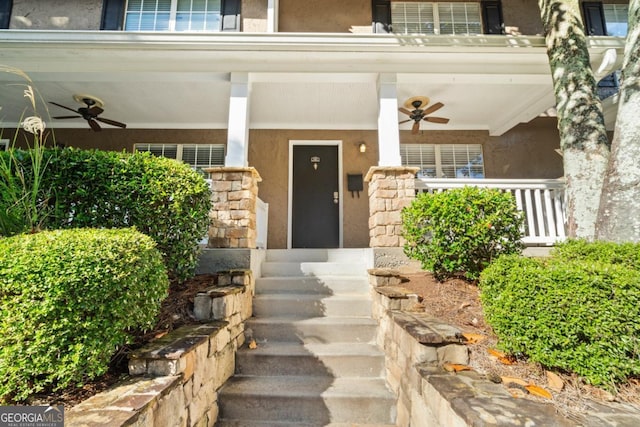 view of exterior entry featuring ceiling fan