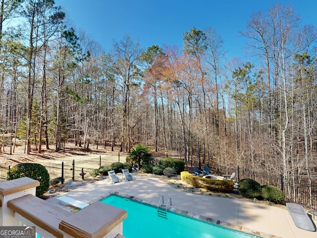 view of pool featuring fence, a fenced in pool, and a patio