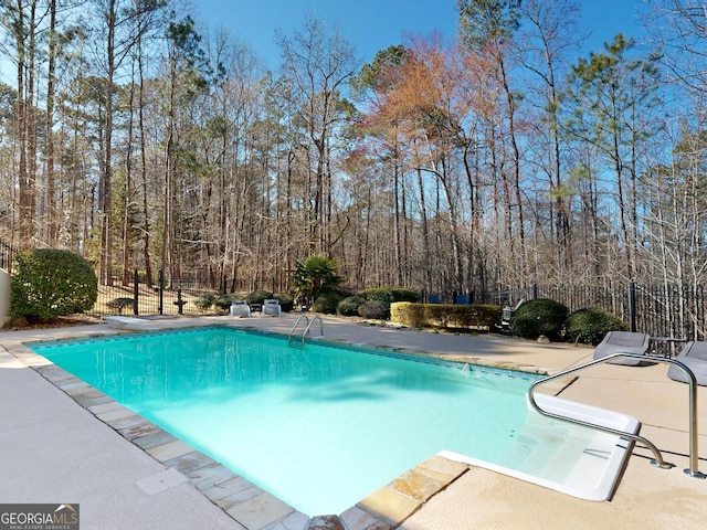 view of swimming pool with a patio area, fence, and a fenced in pool