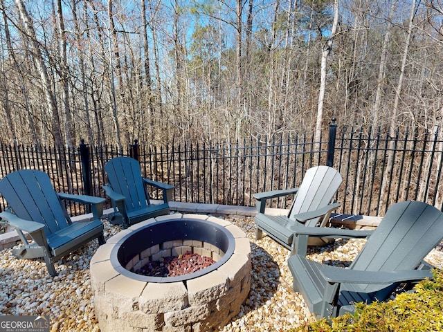 view of patio / terrace with an outdoor fire pit and fence