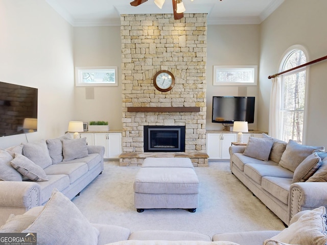 living area featuring ornamental molding, a ceiling fan, and light colored carpet