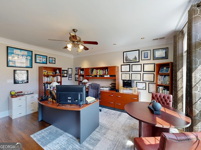 office area with ceiling fan, wood finished floors, visible vents, and crown molding