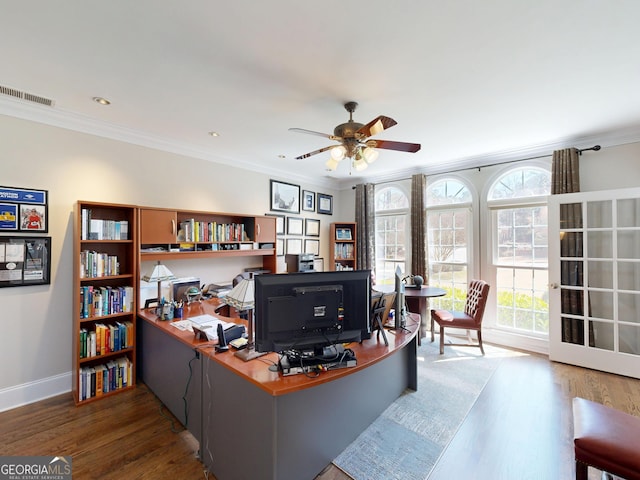 office with visible vents, ornamental molding, ceiling fan, wood finished floors, and baseboards