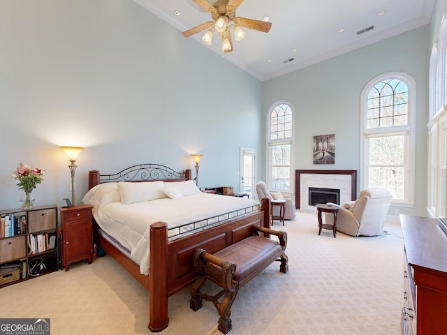 bedroom with light carpet, high vaulted ceiling, ornamental molding, and a fireplace