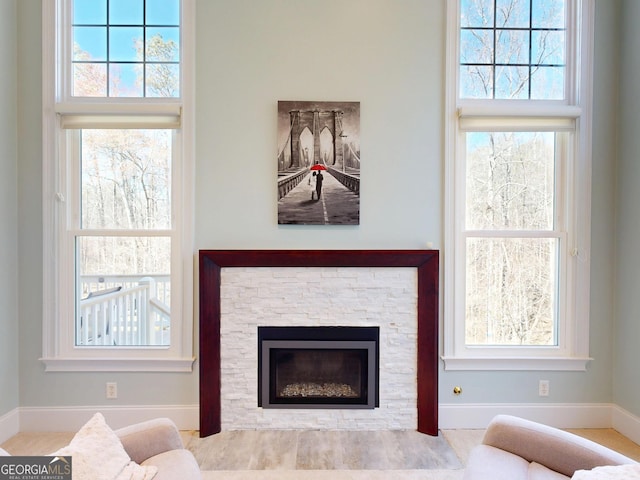 living area featuring a stone fireplace