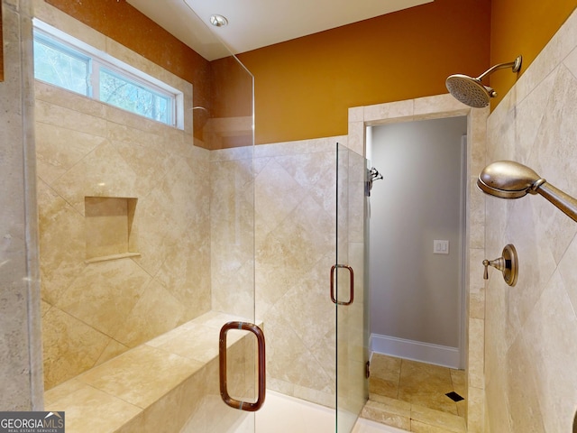 bathroom featuring tile patterned flooring and a shower stall